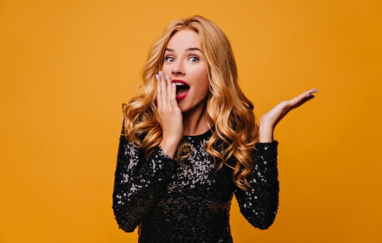 shocked fair haired girl posing yellow wall with mouth open surprised glamorous lady 1